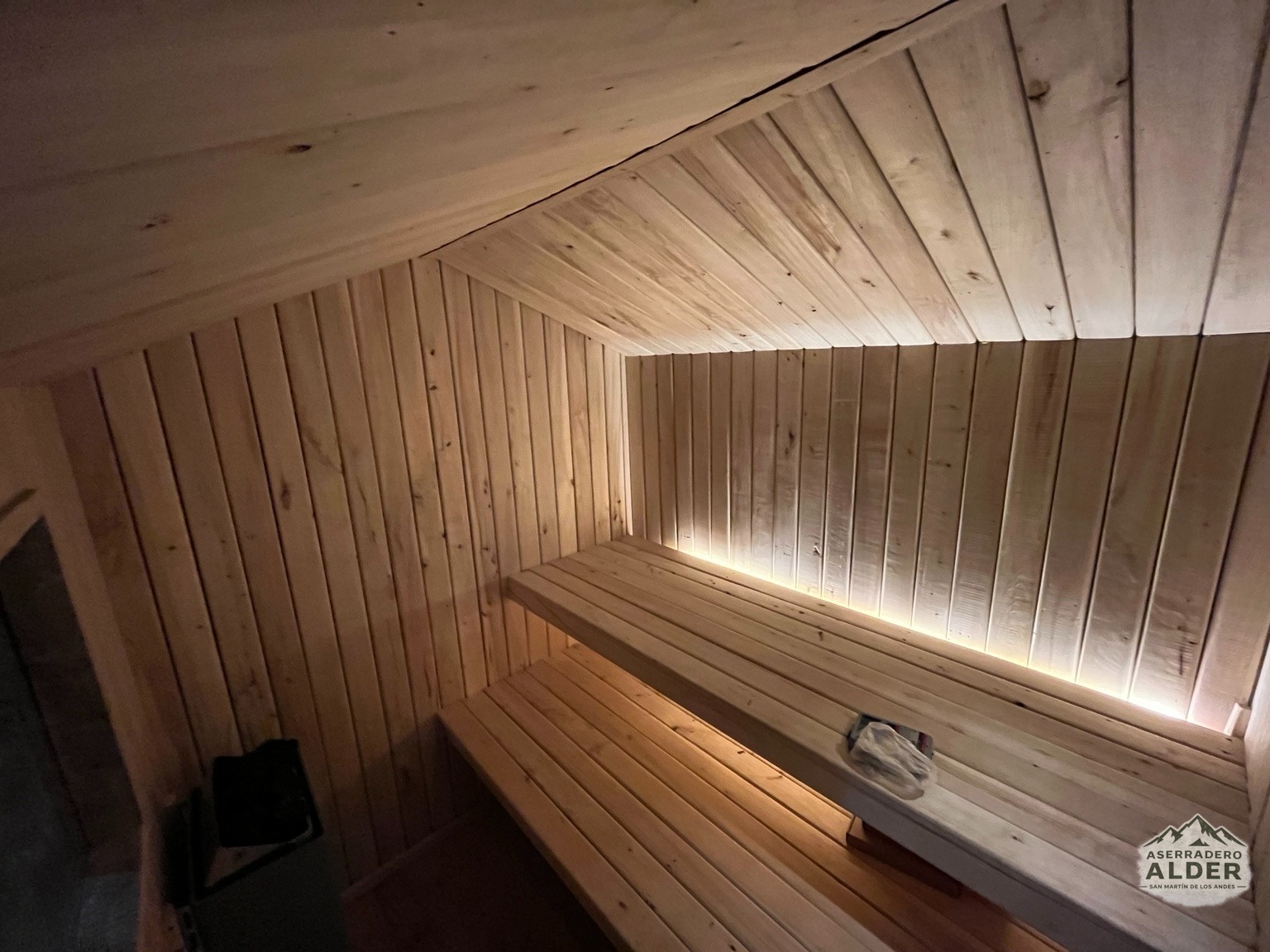 Interior de sauna en madera con bancos e iluminación cálida